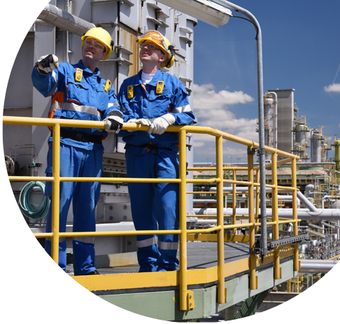 Two men wearing blue suits and yellow vests are standing on a platform. Description generated by AI